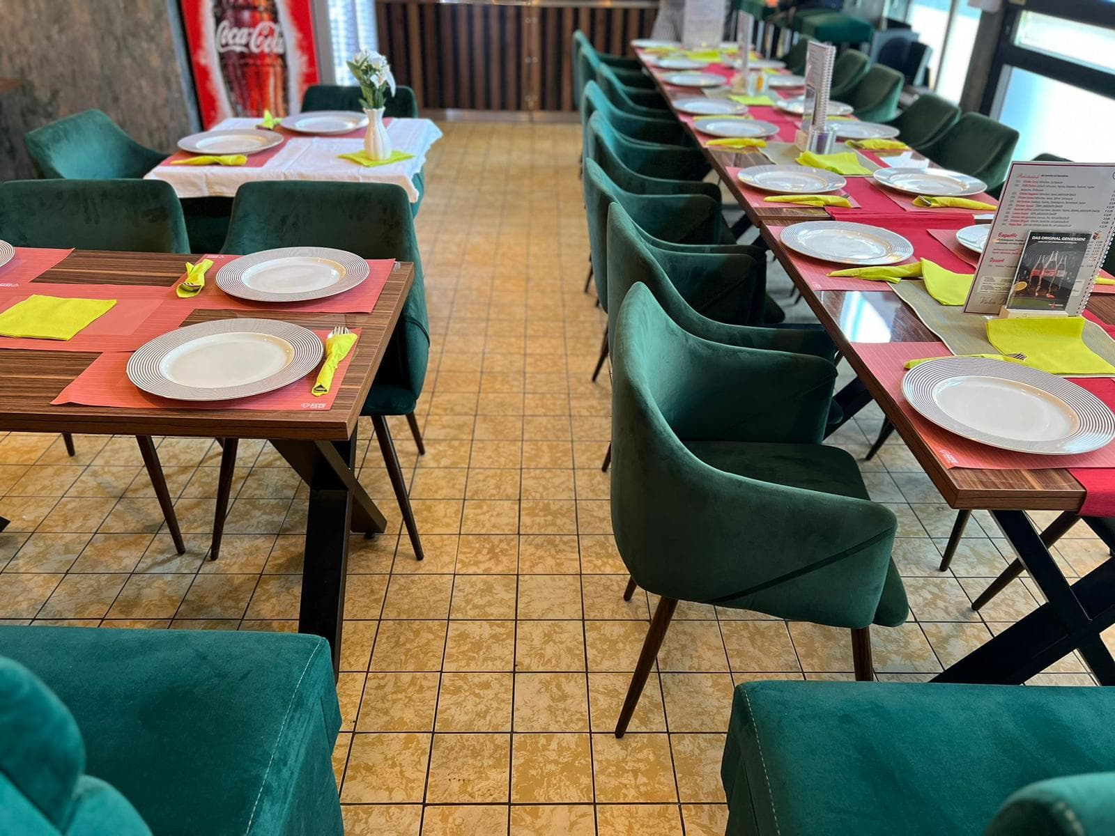 Green velvet chairs with table settings